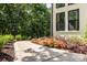 Manicured landscaping with flowerbeds and a winding sidewalk next to the painted-brick home at 6639 Camp Creek Rd, Lancaster, SC 29720