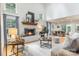 Spacious living room featuring a painted-brick fireplace, hardwood floors, and recessed lighting at 6639 Camp Creek Rd, Lancaster, SC 29720
