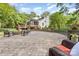 Picturesque backyard showcasing a stone patio with seating, a retaining wall and lush landscaping at 6639 Camp Creek Rd, Lancaster, SC 29720