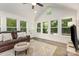 Light-filled sunroom with many windows overlooking backyard and vaulted ceiling at 6639 Camp Creek Rd, Lancaster, SC 29720