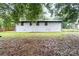 View of the home's exterior featuring a grassy backyard and privacy fence at 818 Stowe Ln, Gastonia, NC 28056