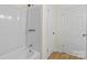 A bathroom featuring an all-white shower and a white door at 818 Stowe Ln, Gastonia, NC 28056