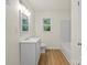 Bright bathroom featuring a single vanity, a tub, a window and wood-look vinyl floors at 818 Stowe Ln, Gastonia, NC 28056