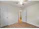 An empty bedroom with light walls, wood floors, and two white doors at 818 Stowe Ln, Gastonia, NC 28056