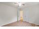 Empty bedroom with light walls, light wood floors, and two white doors at 818 Stowe Ln, Gastonia, NC 28056
