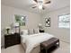 Cozy bedroom featuring neutral walls, two windows, and a stylish ceiling fan at 818 Stowe Ln, Gastonia, NC 28056