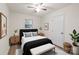 Bright bedroom featuring a ceiling fan, a bed, and two matching bedside tables at 818 Stowe Ln, Gastonia, NC 28056