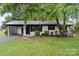 Charming single-story home featuring a carport, painted brick, and manicured lawn at 818 Stowe Ln, Gastonia, NC 28056