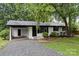 Charming single-story home featuring a carport, painted brick, and manicured lawn at 818 Stowe Ln, Gastonia, NC 28056