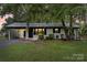 Charming single-story home featuring a carport, painted brick, and manicured lawn at 818 Stowe Ln, Gastonia, NC 28056