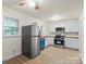 Updated kitchen features white cabinets, stainless appliances, and wood countertops at 818 Stowe Ln, Gastonia, NC 28056