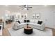 Bright living room featuring a modern sectional sofa, wood floors, and ceiling fan at 818 Stowe Ln, Gastonia, NC 28056