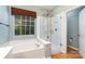Modern bathroom features a separate tub, shower and a window bringing in natural light at 9419 Olivia Ln, Charlotte, NC 28277