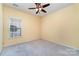 Bright bedroom featuring neutral colors and a ceiling fan at 9419 Olivia Ln, Charlotte, NC 28277