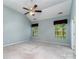 Bright bedroom featuring a ceiling fan and windows with wooded view at 9419 Olivia Ln, Charlotte, NC 28277