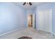A cozy bedroom with a ceiling fan and an inviting doorway at 9419 Olivia Ln, Charlotte, NC 28277