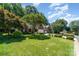 Beautifully landscaped front yard with mature trees enhancing this brick home's curb appeal at 9419 Olivia Ln, Charlotte, NC 28277