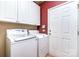 Practical laundry room with white cabinets, washer, and dryer at 9419 Olivia Ln, Charlotte, NC 28277