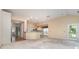 Open-concept living room featuring a kitchen, dining area, and natural light at 9419 Olivia Ln, Charlotte, NC 28277