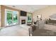 A bright living room has a fireplace, ceiling fan and double glass doors to the outside at 9419 Olivia Ln, Charlotte, NC 28277