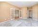 Bright room with a pair of glass french doors leading to another room with beautiful wainscotting at 9419 Olivia Ln, Charlotte, NC 28277