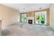 Spacious living room with a fireplace, ceiling fan, and natural light at 9419 Olivia Ln, Charlotte, NC 28277