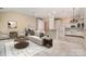 Bright open-concept living room and kitchen featuring a ceiling fan and modern appliances at 9419 Olivia Ln, Charlotte, NC 28277