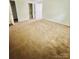 Spacious carpeted bedroom with ensuite bathroom and neutral paint, offering a comfortable living space at 9541 Shannon Green Dr # C, Charlotte, NC 28213