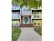 Inviting front entrance with teal door, brick steps and pathway to this charming home at 9541 Shannon Green Dr # C, Charlotte, NC 28213