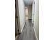 Well-lit hallway features modern flooring and leads to various rooms, creating a seamless flow at 9541 Shannon Green Dr # C, Charlotte, NC 28213