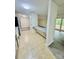 Open-concept kitchen view with a bar to living room with sliding glass doors and bright natural light at 9541 Shannon Green Dr # C, Charlotte, NC 28213