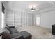 Upstairs bedroom featuring carpet, a gray sofa, and floor-to-ceiling shelving at 1009 Jerry Ln, Matthews, NC 28105