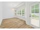 Bright breakfast nook with lots of windows and natural light, and hardwood floors at 1009 Jerry Ln, Matthews, NC 28105