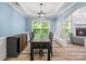A dining room features modern light fixture, beautiful flooring, fireplace, and large windows at 1009 Jerry Ln, Matthews, NC 28105
