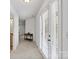 Hallway featuring carpet flooring, an accent table, and double doors at 1009 Jerry Ln, Matthews, NC 28105