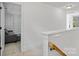 Upstairs hallway featuring carpet, white walls, and access to bedrooms at 1009 Jerry Ln, Matthews, NC 28105