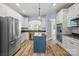 Spacious kitchen with white cabinets, stainless steel appliances, granite counters, and a center island at 1009 Jerry Ln, Matthews, NC 28105