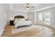 Spacious main bedroom with a tray ceiling, hardwood floors, and access to balcony at 1009 Jerry Ln, Matthews, NC 28105