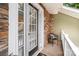 Patio with stone wall, seating, and white trim around the door at 1009 Jerry Ln, Matthews, NC 28105