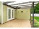 Charming outdoor patio area with a ceiling fan and lighting, ideal for entertaining or relaxation at 1009 Jerry Ln, Matthews, NC 28105