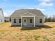 Back exterior of the house, showcasing four windows and a white-framed door at 1071 Bull Dog Ln, Wingate, NC 28174