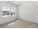 Bright bedroom with neutral carpet, two large windows, and white walls at 1071 Bull Dog Ln, Wingate, NC 28174