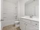 Clean bathroom with a tub/shower combo, white vanity, and tile flooring at 1074 Bull Dog Ln, Wingate, NC 28174