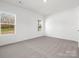 A spacious bedroom with natural light from two large windows at 1074 Bull Dog Ln, Wingate, NC 28174