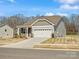 Attractive home with stone accents, neutral siding and an attached two-car garage at 1074 Bull Dog Ln, Wingate, NC 28174