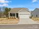 Charming single-story home featuring stone accents, neutral siding, and an attached two-car garage at 1074 Bull Dog Ln, Wingate, NC 28174
