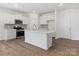 Bright kitchen with stainless appliances, a center island, and white cabinetry at 1074 Bull Dog Ln, Wingate, NC 28174
