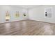 Bright and airy living room with multiple windows and wood-look flooring at 1074 Bull Dog Ln, Wingate, NC 28174