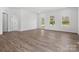 Well-lit living room with wood-look floors and a view to the exterior at 1074 Bull Dog Ln, Wingate, NC 28174