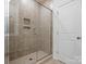 Shower featuring glass doors and tiled walls at 1074 Bull Dog Ln, Wingate, NC 28174